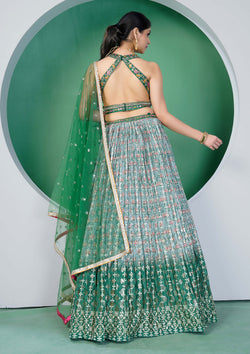 A beautiful green and gold embroidered lehenga choli, a traditional Indian outfit for women.