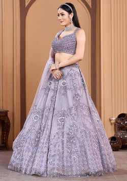 Traditional Indian dress: woman in purple lehenga choli, looking stunning.