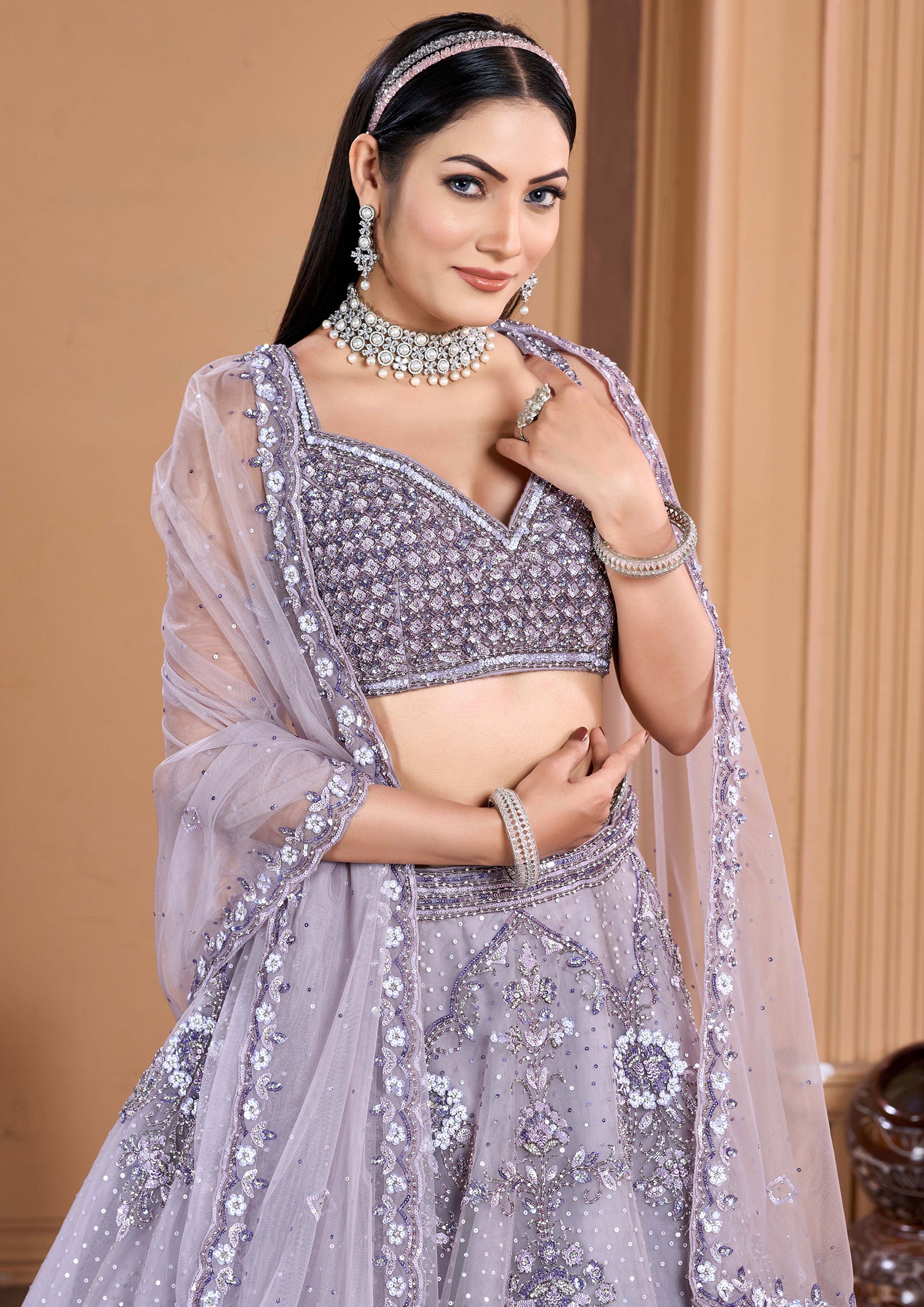 Traditional Indian dress: woman in purple lehenga choli, looking stunning.