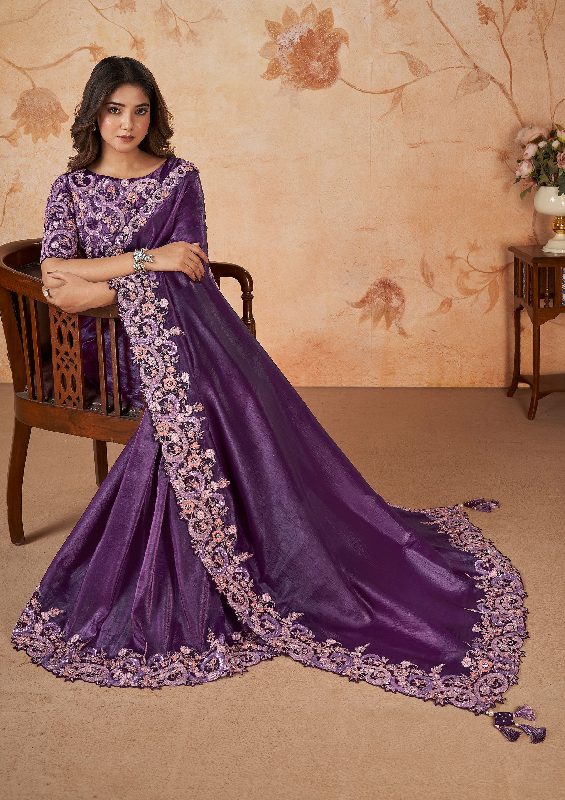  Elegant purple saree adorned with floral designs.