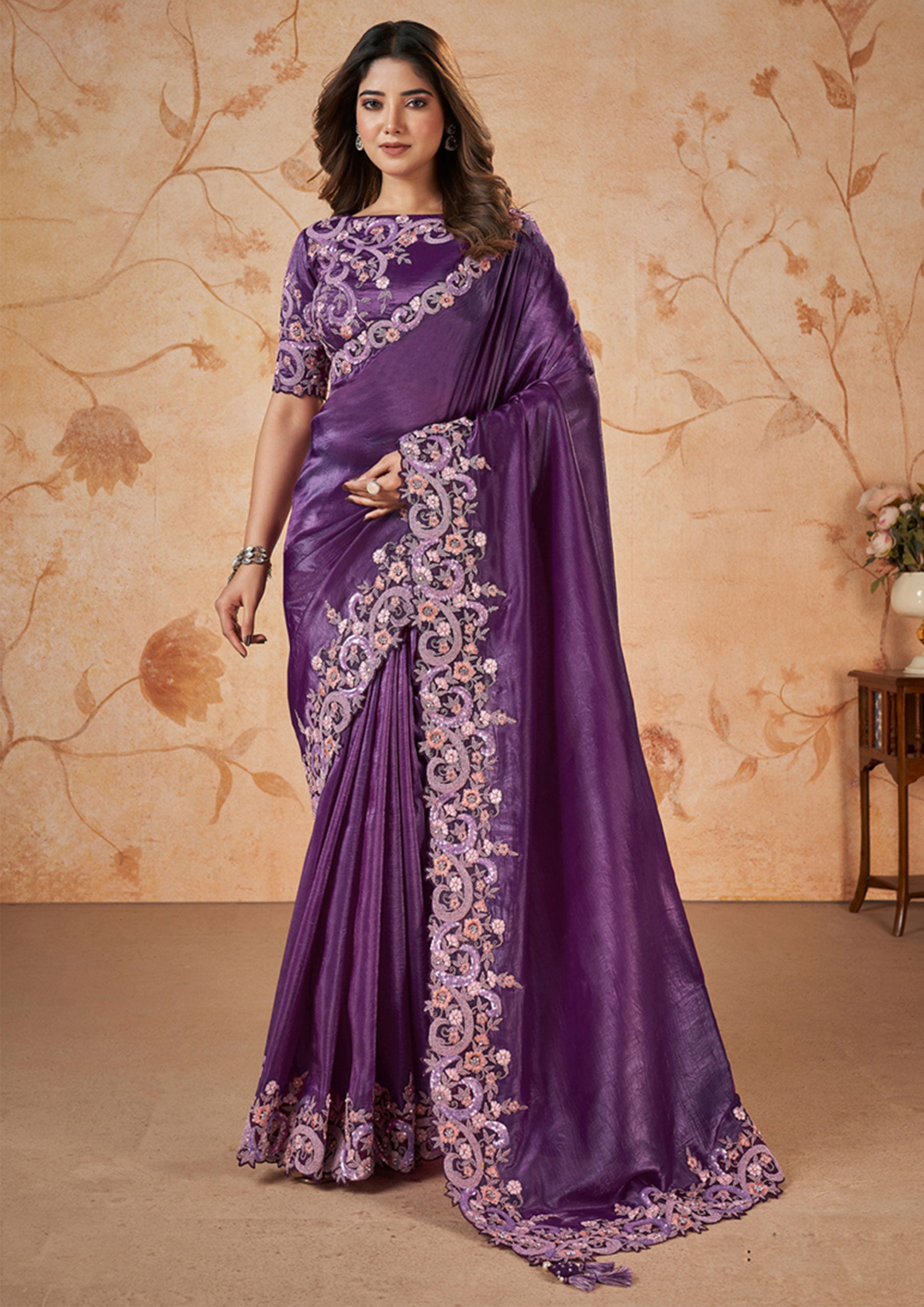  Elegant purple saree adorned with floral designs.