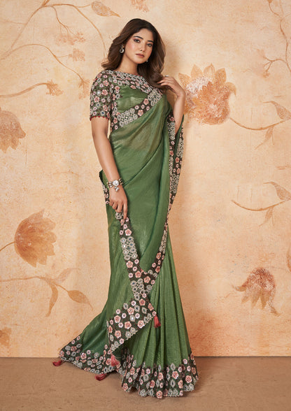 Green and brown printed silk saree with intricate floral patterns.