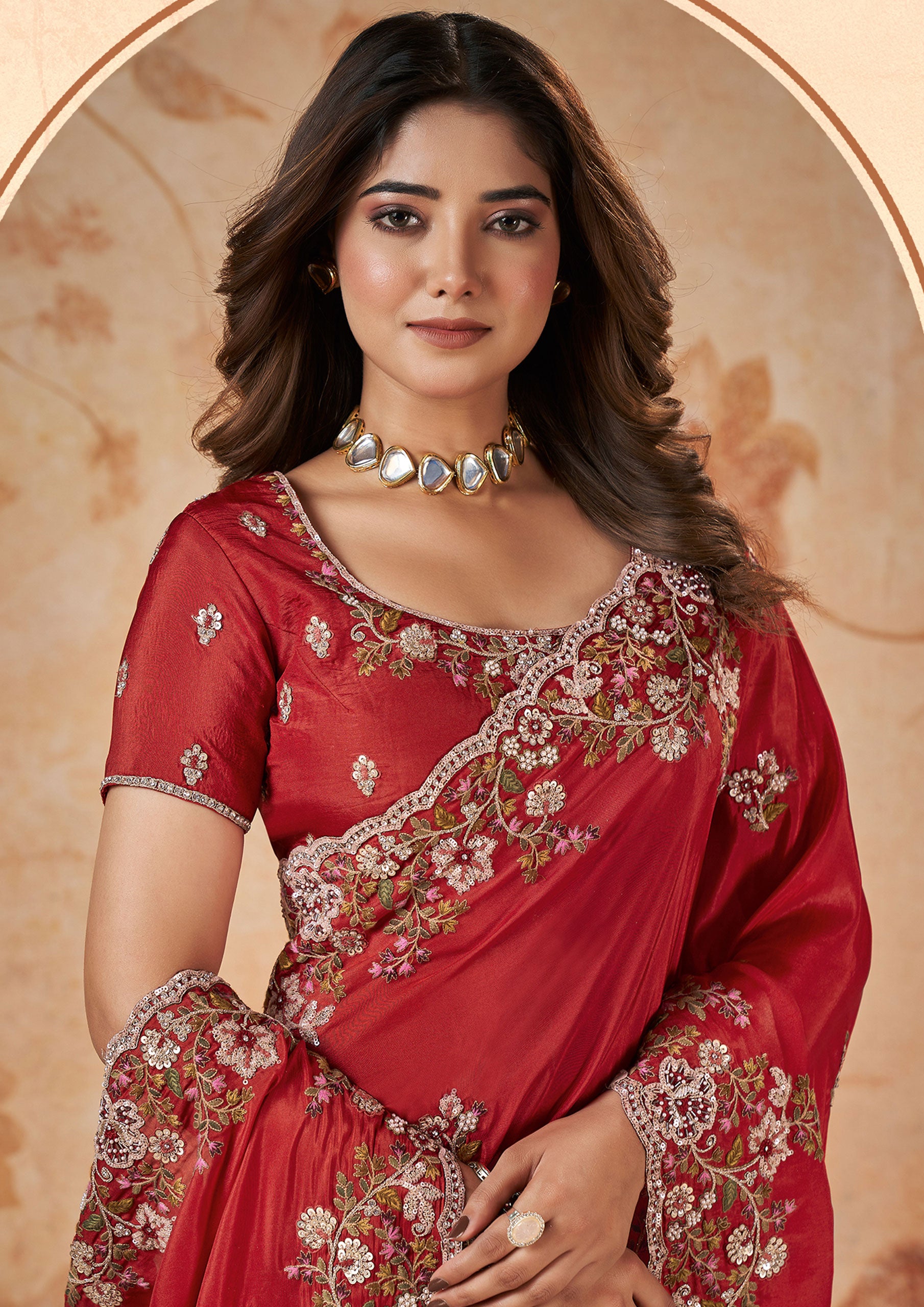 A vibrant red saree with intricate embroidery, showcasing traditional craftsmanship and elegance.