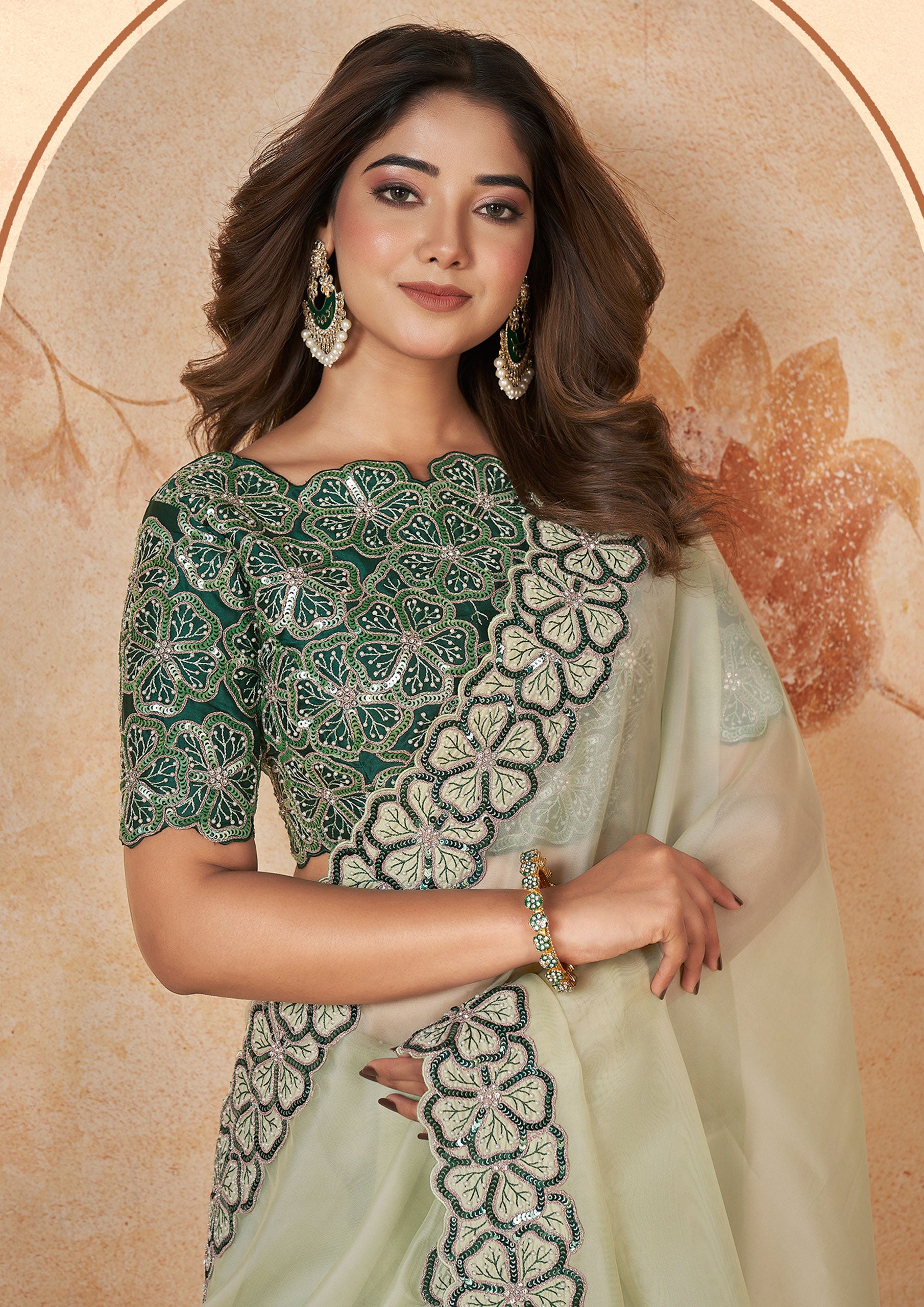 Green saree with intricate embroidery, paired with a matching embroidered blouse.