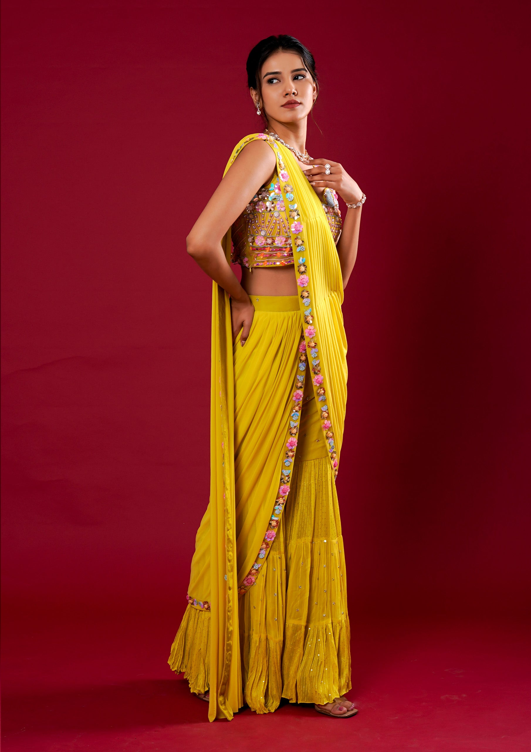 A stunning yellow georgette saree featuring exquisite hand work.