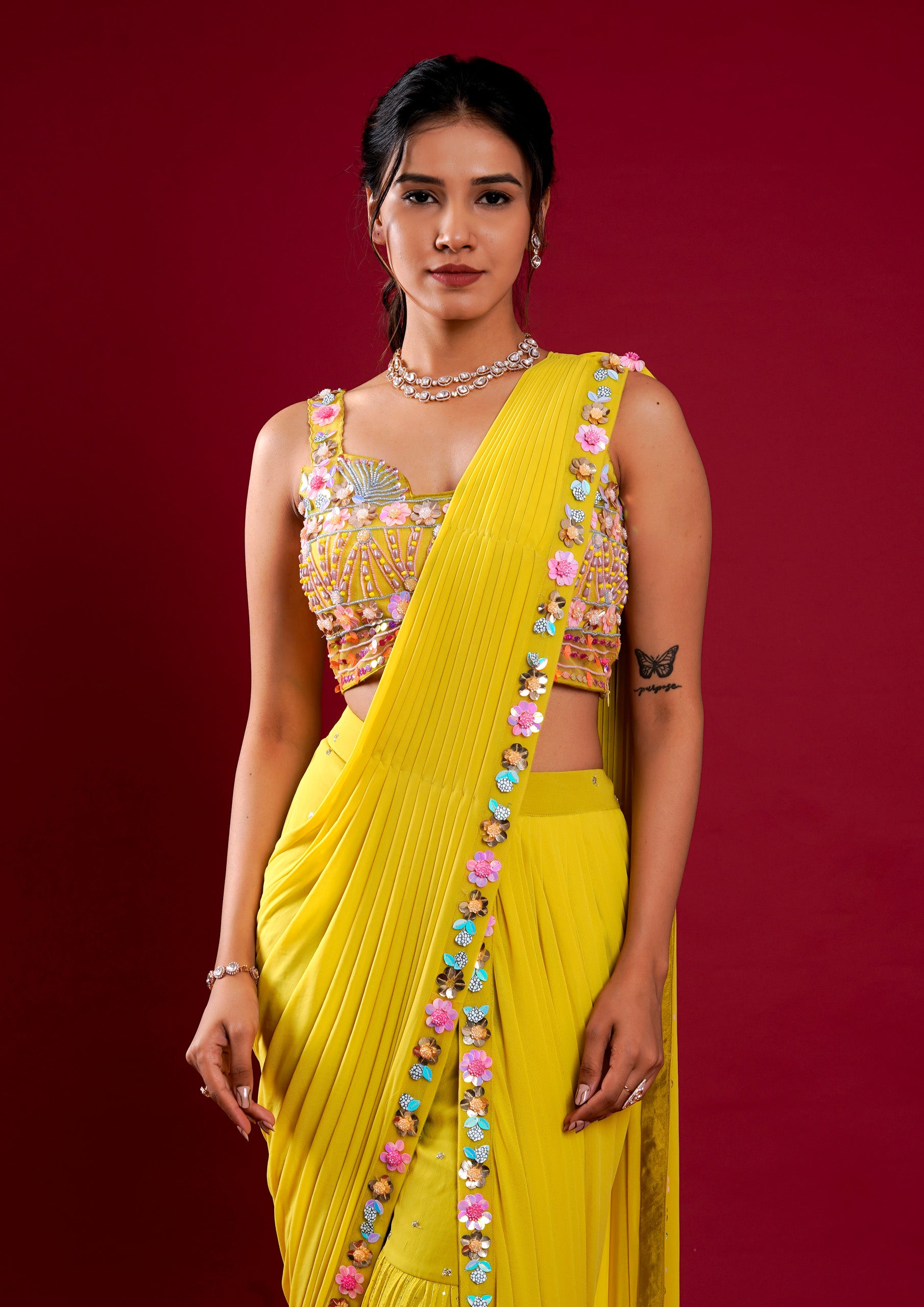 A stunning yellow georgette saree featuring exquisite hand work.