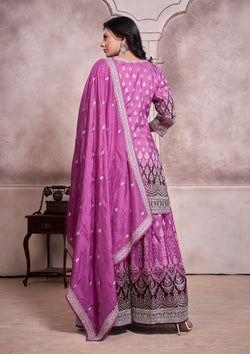 A purple embroidered suit with a matching dupatta, showcasing intricate designs and vibrant colors.