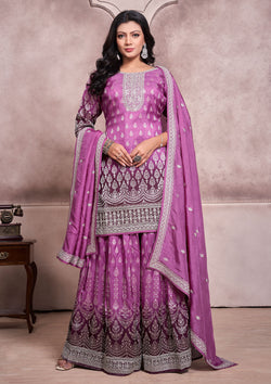 A purple embroidered suit with a matching dupatta, showcasing intricate designs and vibrant colors.