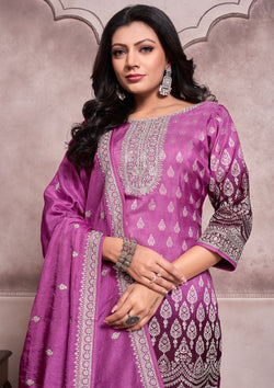 A purple embroidered suit with a matching dupatta, showcasing intricate designs and vibrant colors.