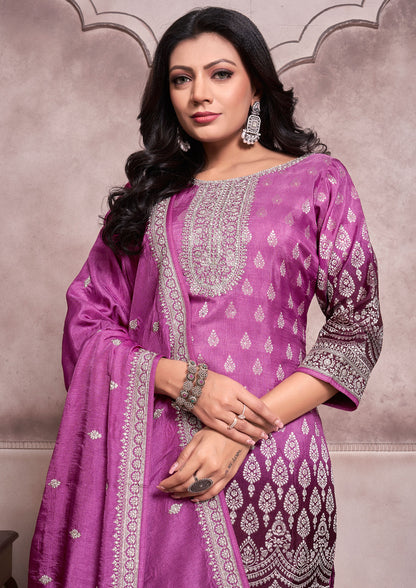 A purple embroidered suit with a matching dupatta, showcasing intricate designs and vibrant colors.